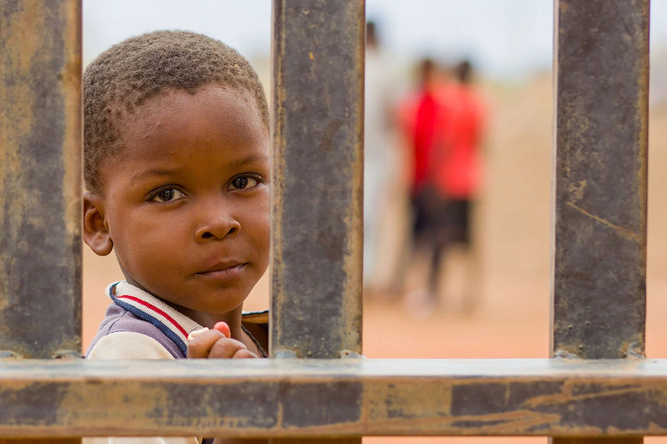 A little boy looks into the camera.