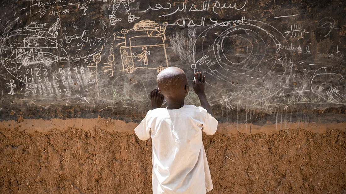 Boy on a blackboard.